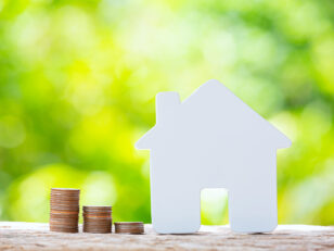 World Habitat Day,close up picture of a pile of coins and a mode