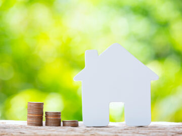 World Habitat Day,close up picture of a pile of coins and a mode